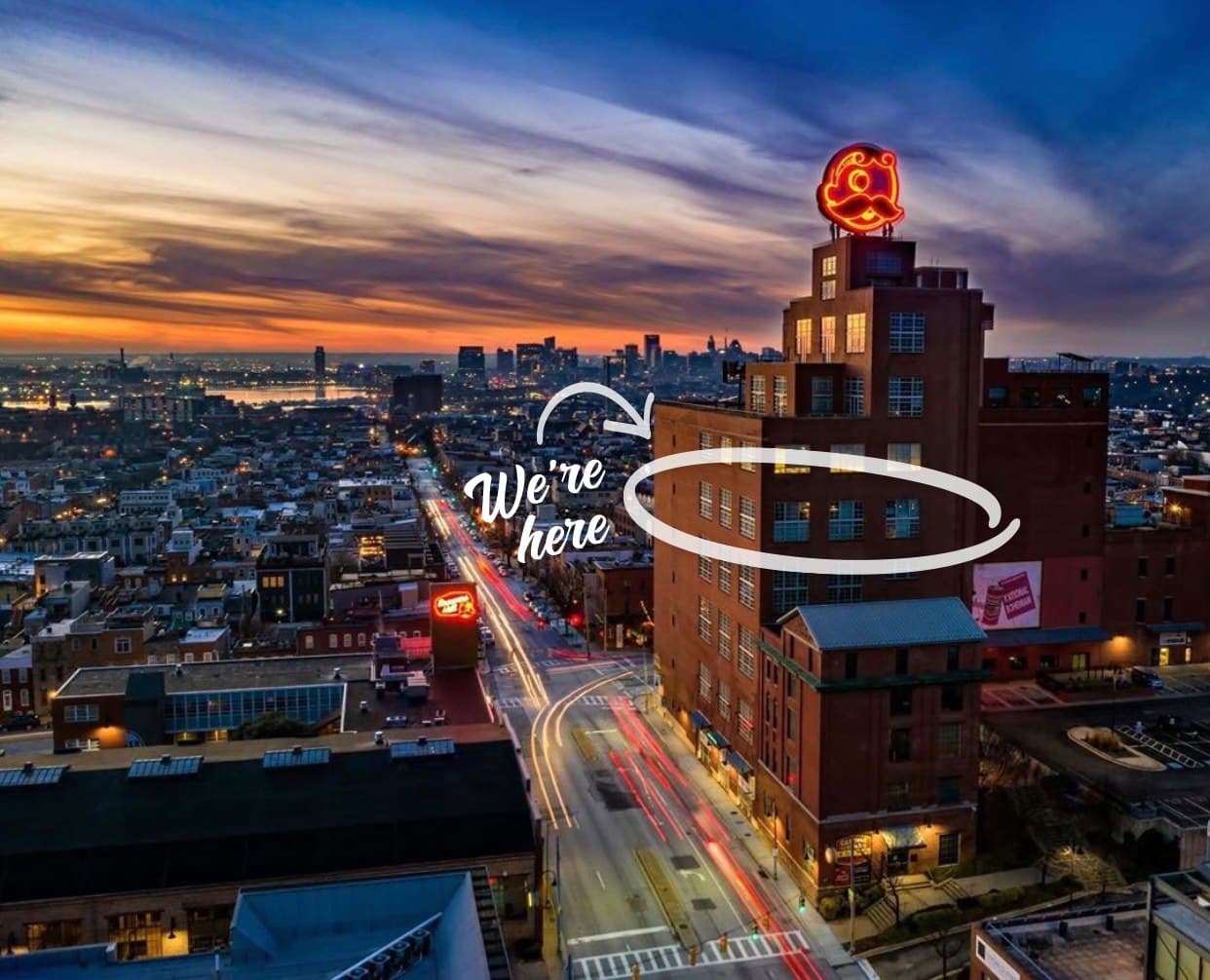 The Natty Boh Tower in Baltimore at dusk, with the Response Labs office circled and marked 'We're here'.