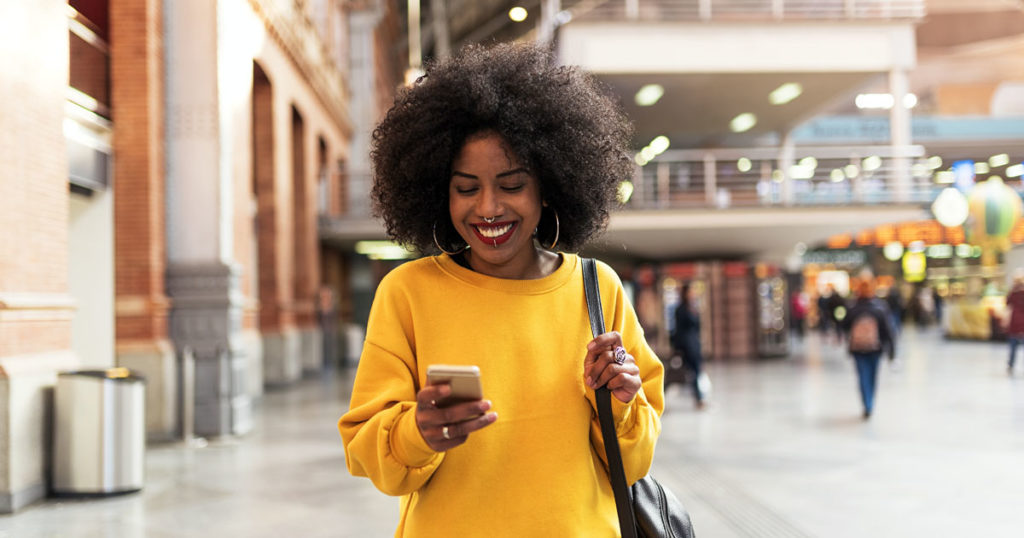 Beautiful woman using mobile in the train station