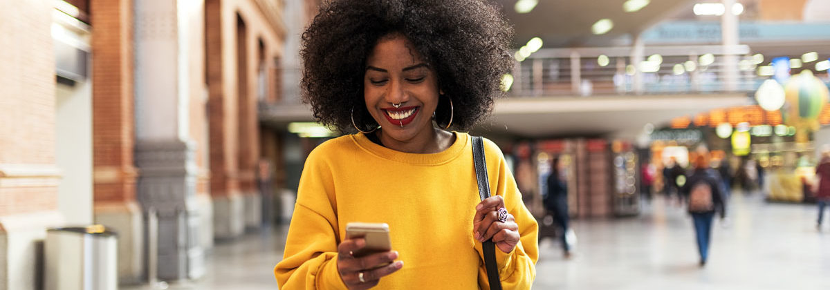 Beautiful woman using mobile in the train station