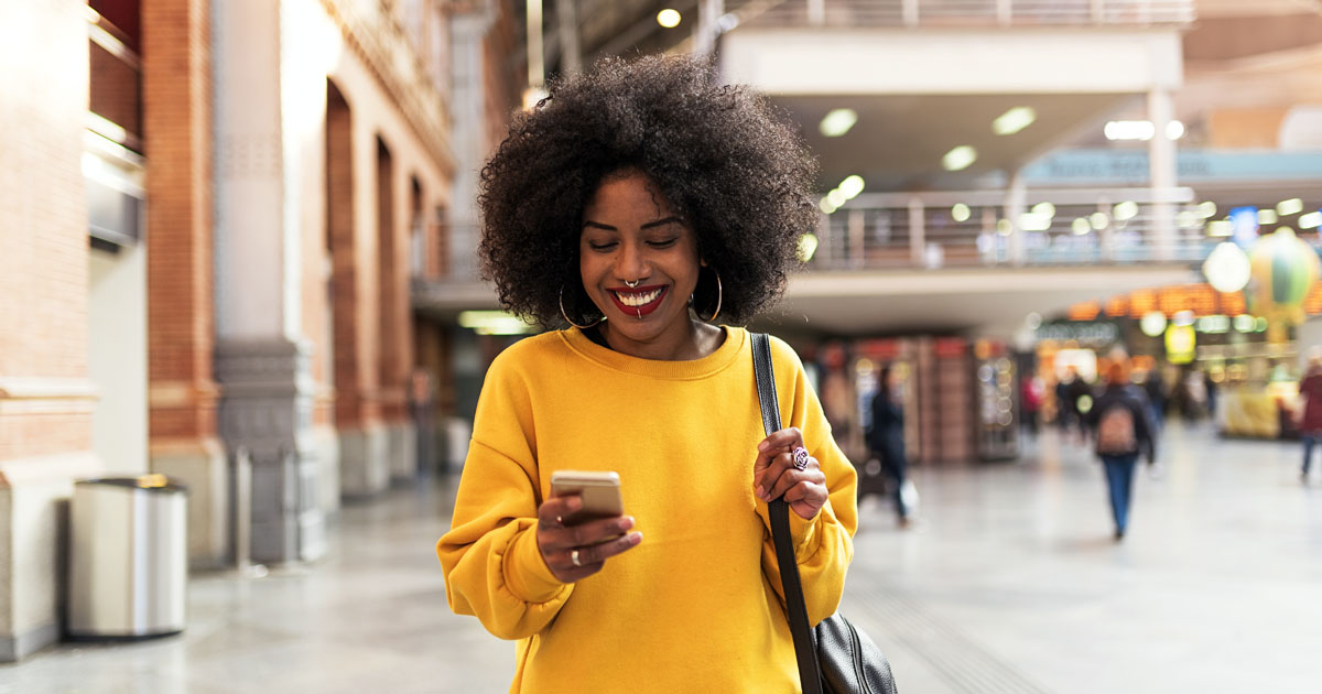 Beautiful woman using mobile in the train station