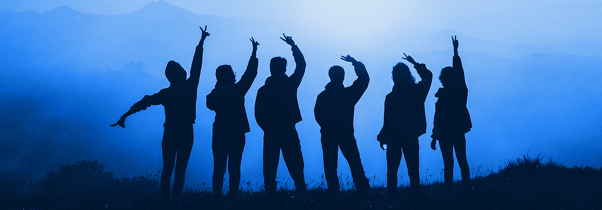 Six people silhouetted, hands raised