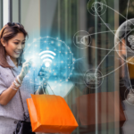 A woman stands outside a clothing store holding shopping bags and a cellphone. The cellphone has graphics representing the internet and omnichannel marketing coming out of it.