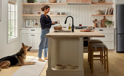 Woman in kitchen with dog